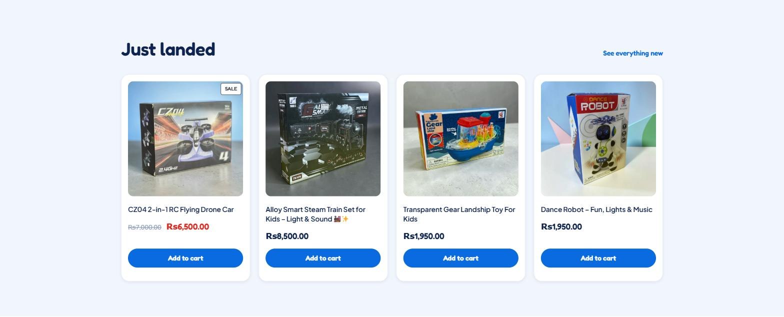 The Just landed row on the Unique Toy Shop homepage, showing four product cards with photographs, names and rupee prices. The first is marked SALE with Rs7,000 struck through and Rs6,500 beside it in red